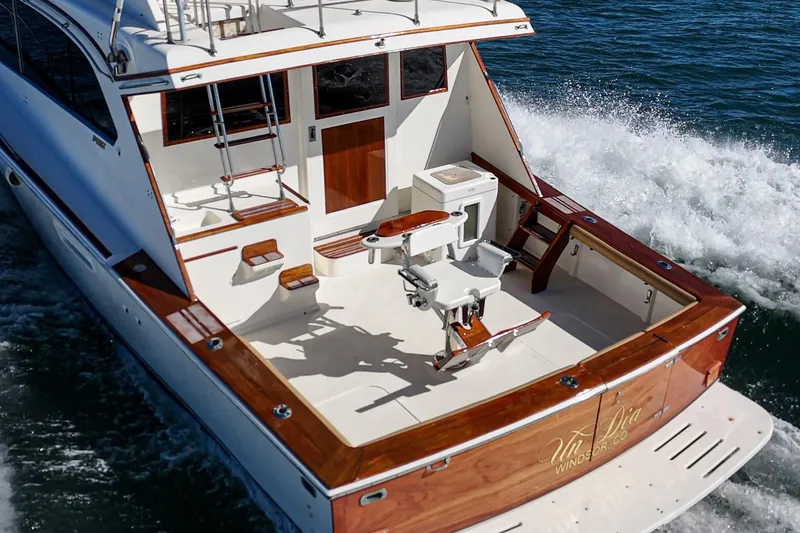 Slide: The Image of Luxury 1984 Post 43 yacht cruising on water, featuring elegant wood finishes and spacious deck. - 32