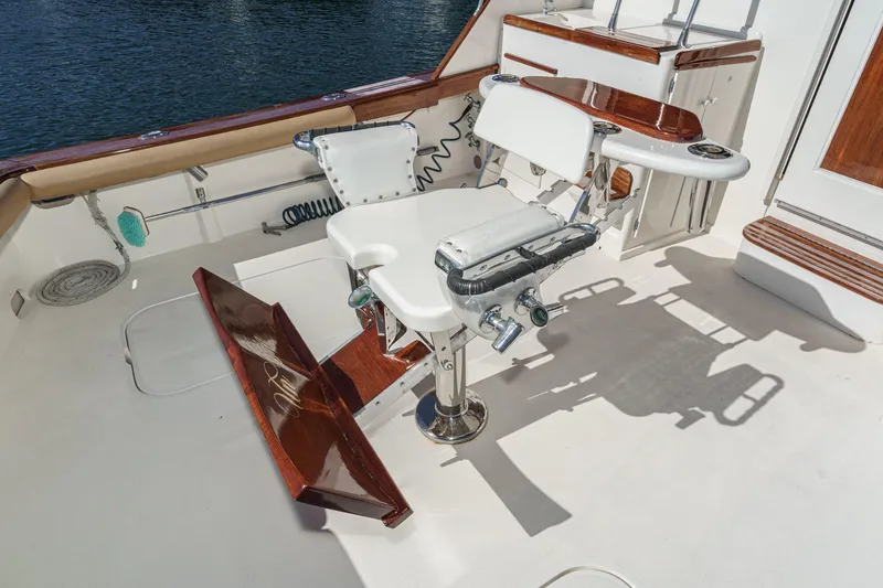 Slide: The Image of Fishing chair on 1984 Post 43 yacht deck, featuring wood accents and ocean backdrop. - 37