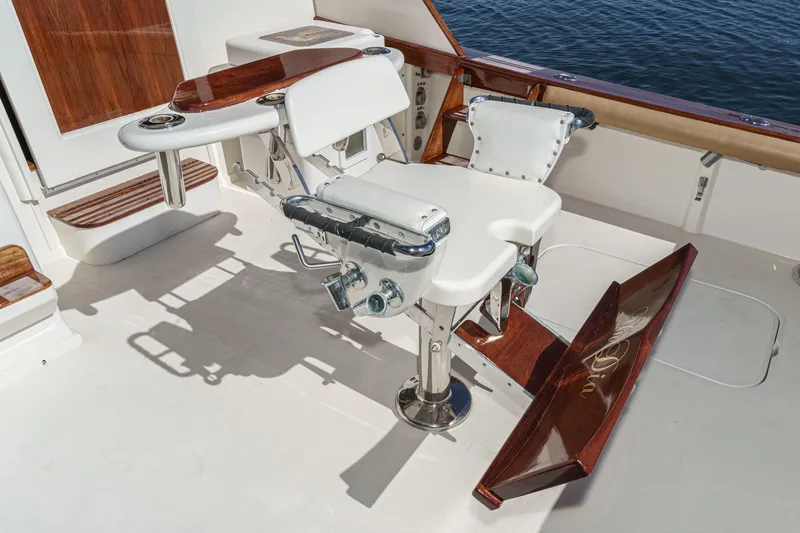 Slide: The Image of Luxury fishing chair on 1984 Post 43 yacht, featuring polished wood and ocean backdrop. - 38