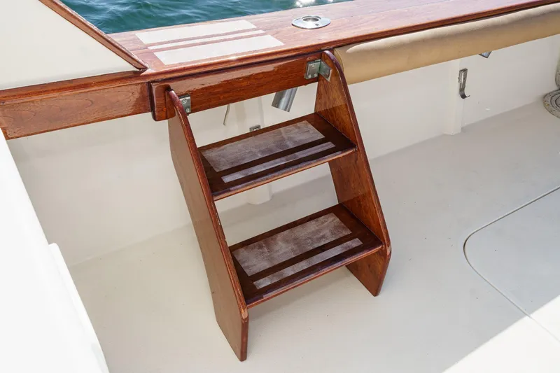 Slide: The Image of Wooden boat steps on a 1984 Post 43 model, leading to the deck. - 44