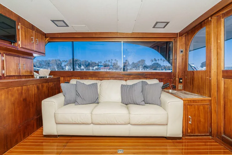 Slide: The Image of Luxurious 1984 Post 43 yacht interior with white sofa and wooden accents. - 48