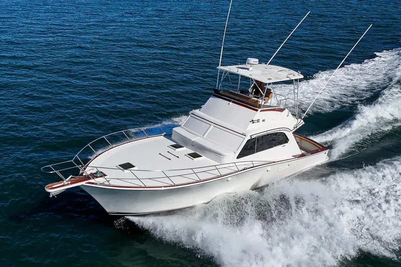 Slide: The Image of 1984 Post 43 yacht cruising on open water, creating a dynamic wake. - 5