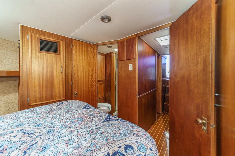 Slide: The Image of Cozy 1984 Post 43 yacht cabin with wooden interior and patterned bedding. - 58