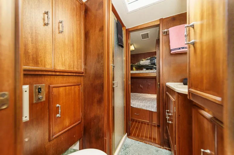 Slide: The Image of Wood-paneled interior of a 1984 Post 43 yacht with cozy cabin and storage. - 59