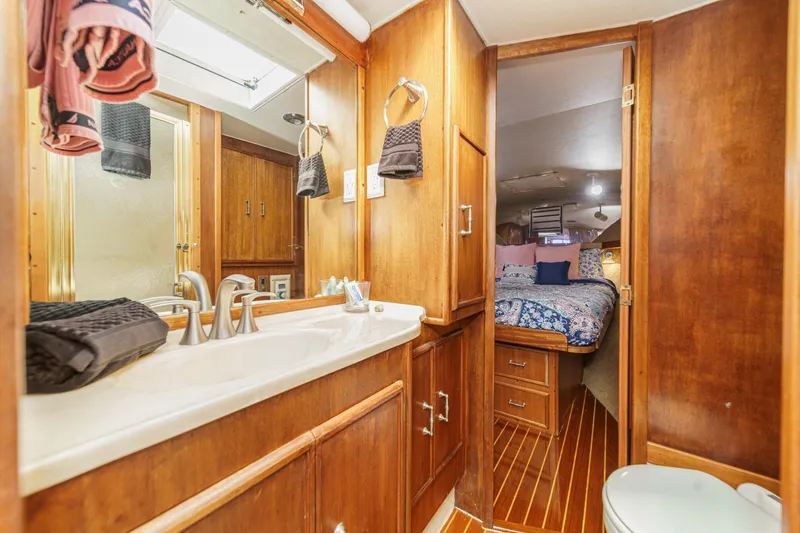 Slide: The Image of Cozy 1984 Post 43 yacht bathroom with wooden cabinetry and adjacent bedroom. - 60