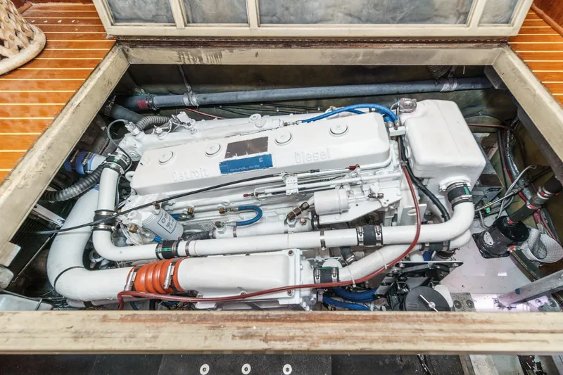 Slide: The Image of Engine compartment of a 1984 Post 43 boat, showcasing a diesel engine. - 64