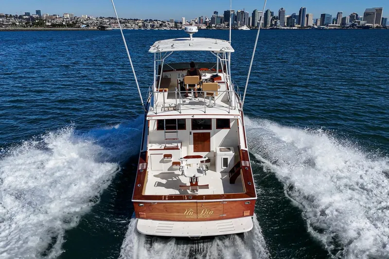 Slide: The Image of A 1984 Post 43 yacht cruising on water with city skyline in the background. - 8