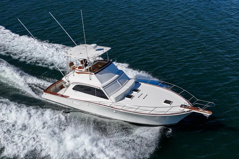 Slide: The Image of 1984 Post 43 yacht cruising on open water, showcasing sleek design and performance. - 9