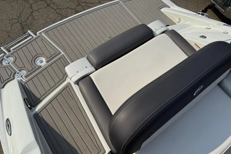Slide: The Image of 2023 Crownline 260 SS boat with sleek seating and textured deck design. - 13
