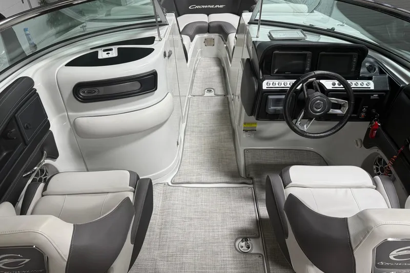 Slide: The Image of 2023 Crownline 260 SS boat interior with modern dashboard and seating. - 4