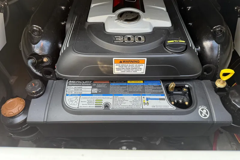 Slide: The Image of Engine of 2023 Crownline 260 SS boat with Mercury components and warning labels. - 8