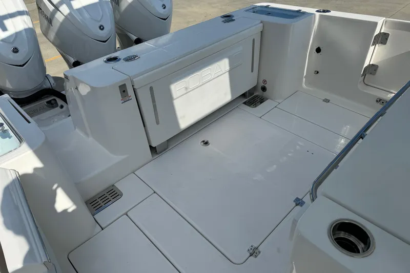 Slide: The Image of 2025 Robalo R360 Center Console boat deck with triple outboard engines. - 12