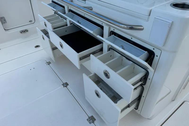 Slide: The Image of Open storage drawers on 2025 Robalo R360 Center Console boat. - 16