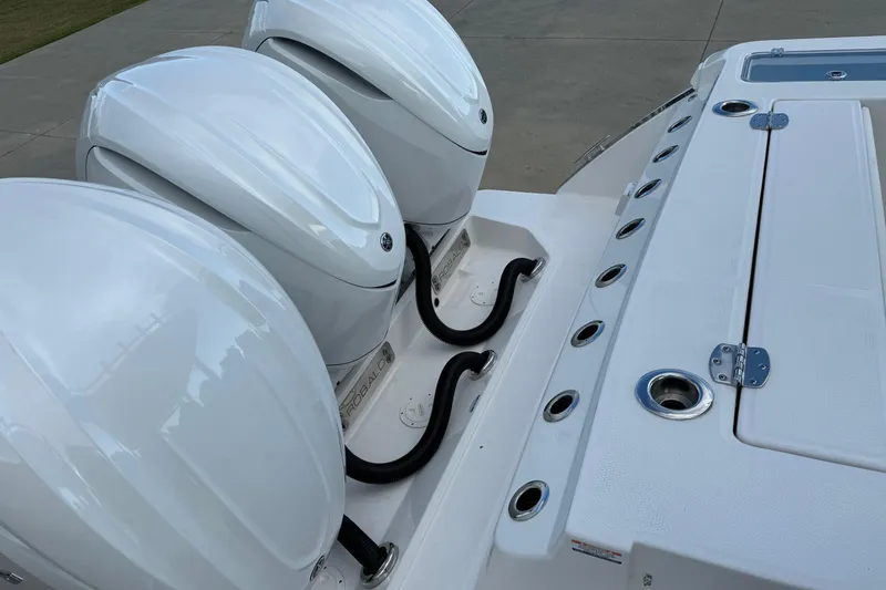 Slide: The Image of 2025 Robalo R360 Center Console with triple outboard engines, sleek design. - 18