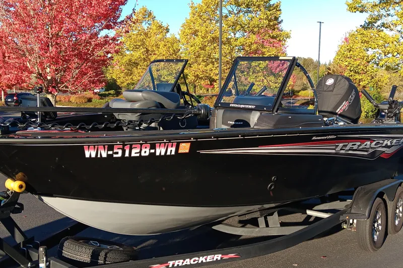 The Image of 2024 Tracker Targa V-19 WT Tournament Edition boat on trailer, autumn trees in background. - 0