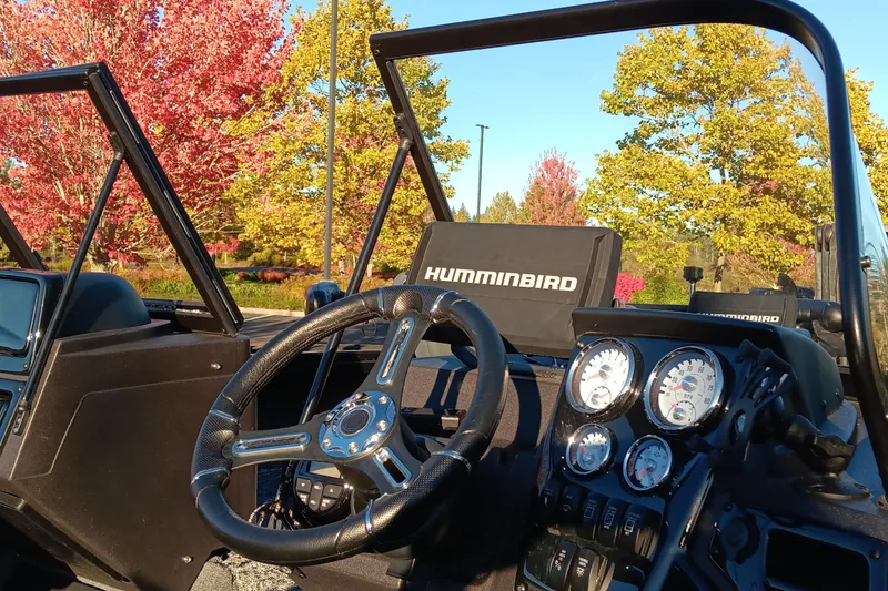 Slide: The Image of 2024 Tracker Targa V-19 WT Tournament Edition dashboard with steering wheel and gauges, autumn trees in background. - 3