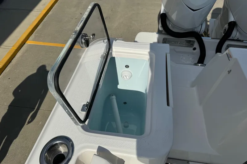 Slide: The Image of 2025 Robalo R360 Center Console livewell with open lid, showcasing interior features. - 14