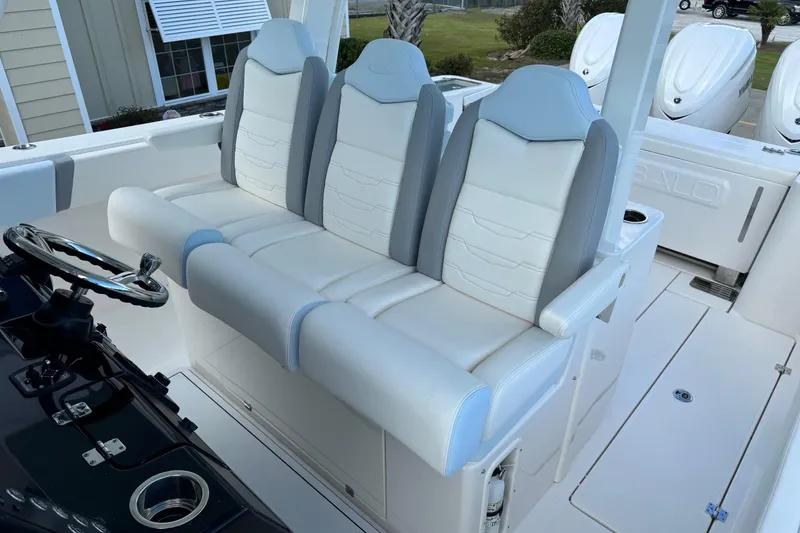 Slide: The Image of 2025 Robalo R360 Center Console boat with sleek white and gray seating. - 21