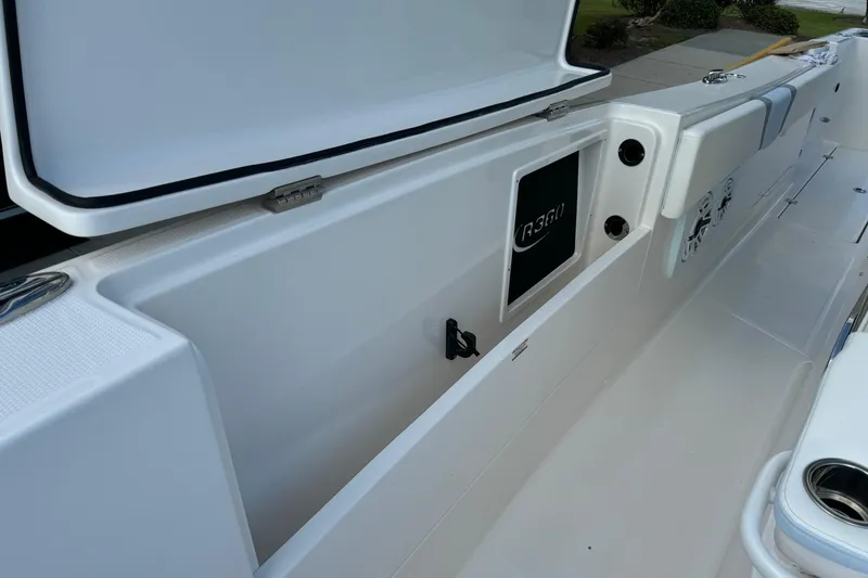 Slide: The Image of 2025 Robalo R360 Center Console boat interior with open storage compartment. - 26