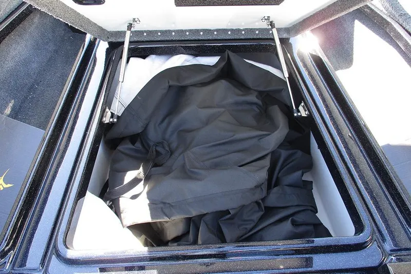 Slide: The Image of Open storage compartment in 2026 Phoenix 818 Pro boat, containing black fabric. - 13