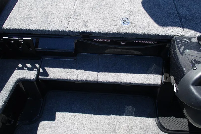 Slide: The Image of Interior of 2026 Phoenix 818 Pro boat with carpeted flooring and storage compartments. - 17