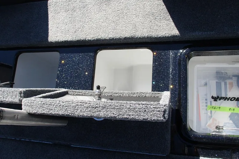 Slide: The Image of Interior view of a 2026 Phoenix 818 Pro boat storage compartment with carpeted surfaces. - 32