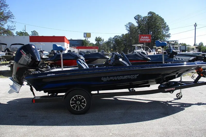 Slide: The Image of 2026 Phoenix 818 Pro boat on trailer, parked outdoors in a dealership lot. - 6