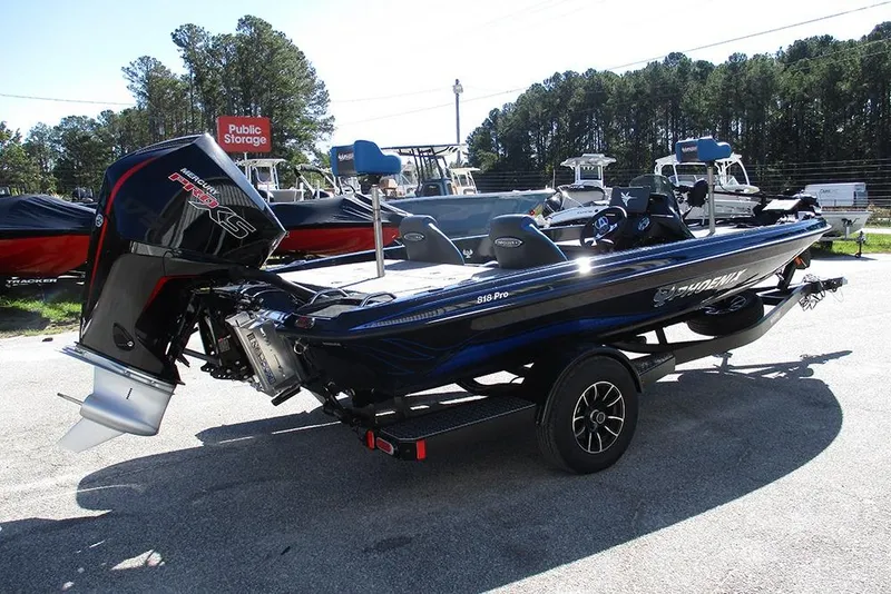 Slide: The Image of 2026 Phoenix 818 Pro boat with Mercury engine, parked outdoors on a trailer. - 7