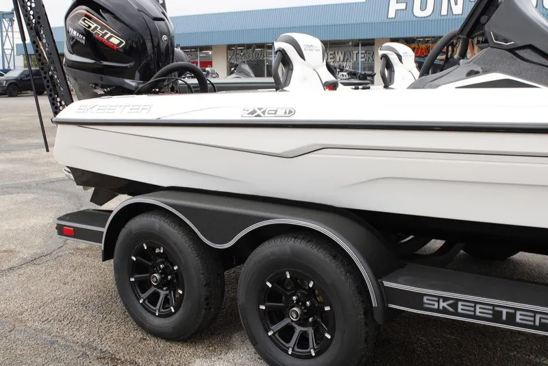 Slide: The Image of 2026 Skeeter ZXE21 boat on trailer, featuring sleek design and dual wheels. - 1
