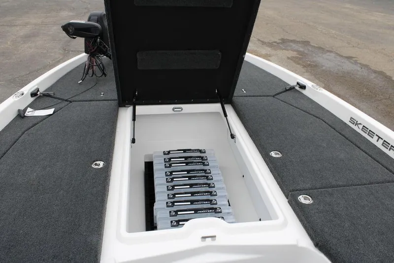 Slide: The Image of 2026 Skeeter ZXE21 boat with open storage compartment and organized tackle boxes. - 11