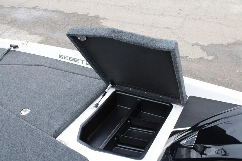 Slide: The Image of 2026 Skeeter ZXE21 boat storage compartment with open lid, showcasing interior space. - 21