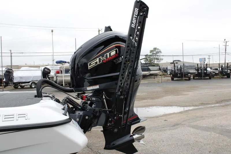 Slide: The Image of 2026 Skeeter ZXE21 boat with powerful outboard motor in a marina setting. - 7