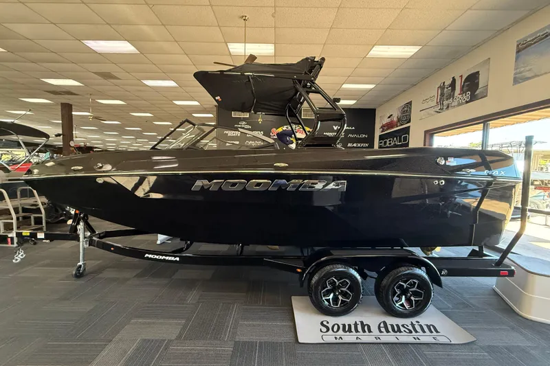 The Image of 2026 Moomba Max boat in showroom, sleek black design, displayed at South Austin Marine. - 1