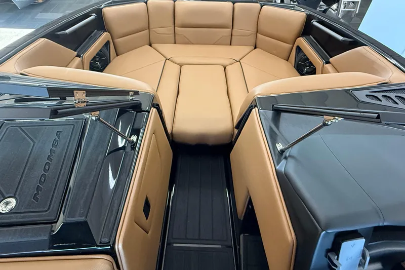 Slide: The Image of 2026 Moomba Max boat interior with tan seating and sleek black accents. - 10