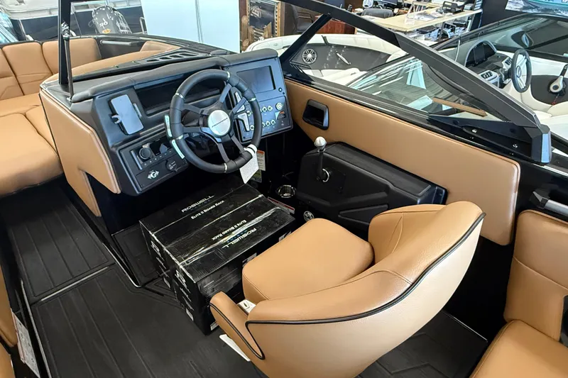Slide: The Image of 2026 Moomba Max boat interior with tan leather seats and modern dashboard. - 14