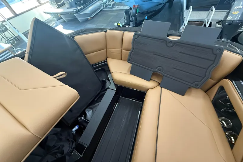 Slide: The Image of 2026 Moomba Max boat interior with tan seating and storage compartments. - 19