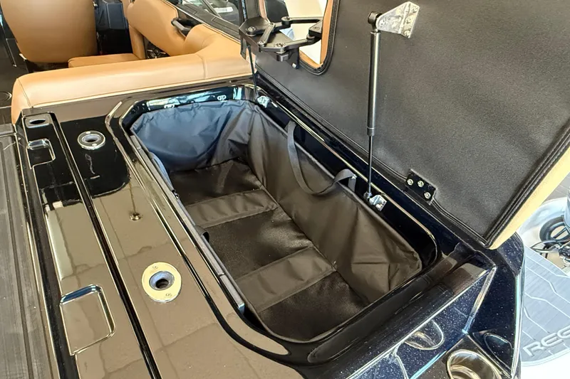 Slide: The Image of Open storage compartment in 2026 Moomba Max boat with tan seating. - 7