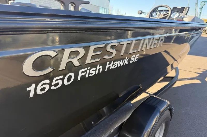 Slide: The Image of 2020 Crestliner 1650 Fish Hawk SE SC boat, side view with logo. - 12