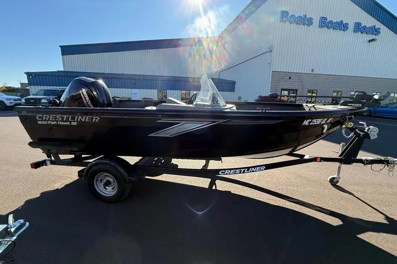 Slide: The Image of 2020 Crestliner 1650 Fish Hawk SE SC boat on trailer, parked outside dealership. - 2