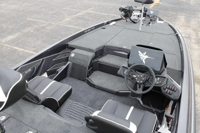 Slide: The Image of 2026 Skeeter ZXE20 boat interior with steering wheel and seating, showcasing modern design. - 15