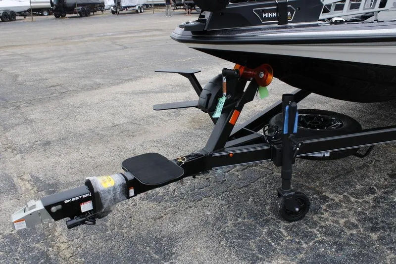 Slide: The Image of 2026 Skeeter ZXE20 boat trailer hitch on asphalt, featuring Minn Kota equipment. - 20