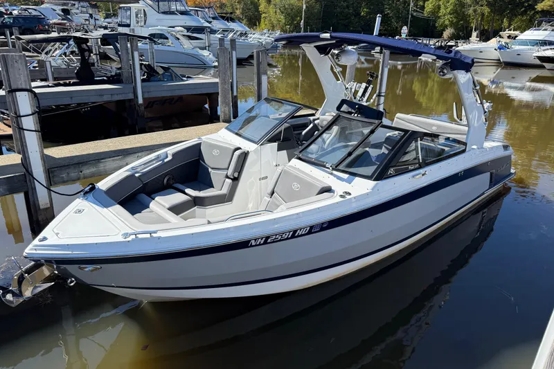 Slide: The Image of 2021 Cobalt R6 Surf boat docked in a marina, featuring sleek design and modern amenities. - 1
