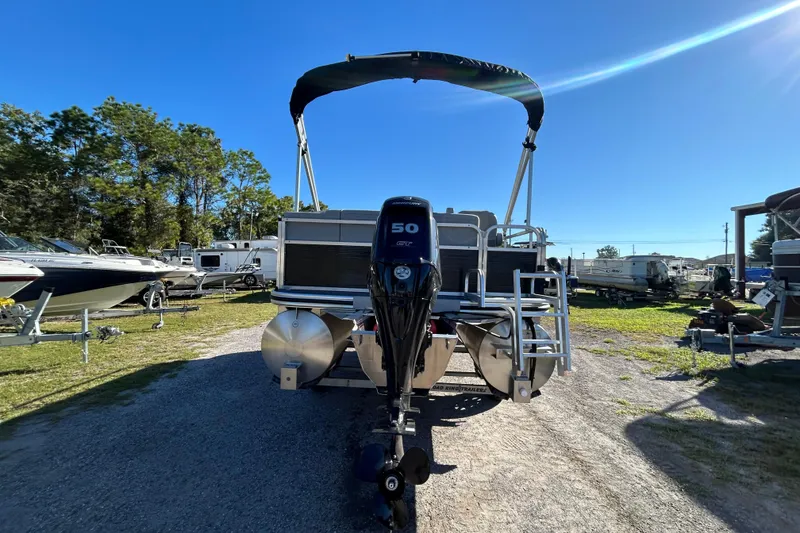 Slide: The Image of 2023 Lowe Ultra 162 Fish & Cruise pontoon boat with outboard motor in a marina. - 14