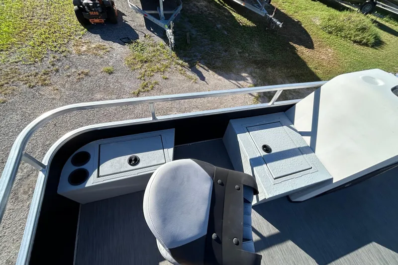 Slide: The Image of 2023 Lowe Ultra 162 Fish & Cruise boat interior with seating and storage compartments. - 18