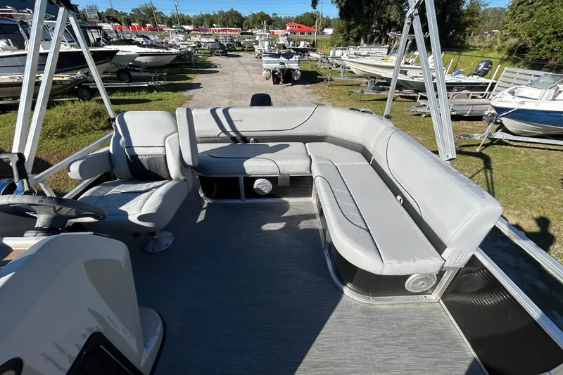 Slide: The Image of 2023 Lowe Ultra 162 Fish & Cruise boat interior with gray seating and steering wheel. - 20