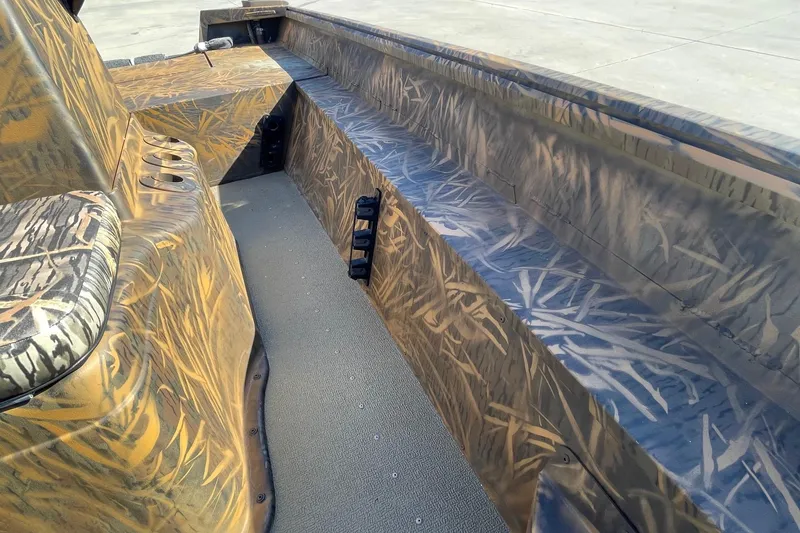 Slide: The Image of 2026 G3 17 CC Shadow Grass boat interior with camouflage design and seating. - 14