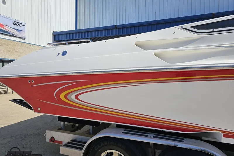 Slide: The Image of 2007 Fountain 35 Lightning boat with red and yellow accents on a trailer. - 10