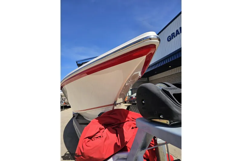 Slide: The Image of 2007 Fountain 35 Lightning boat with red accents, parked outdoors under clear blue sky. - 16
