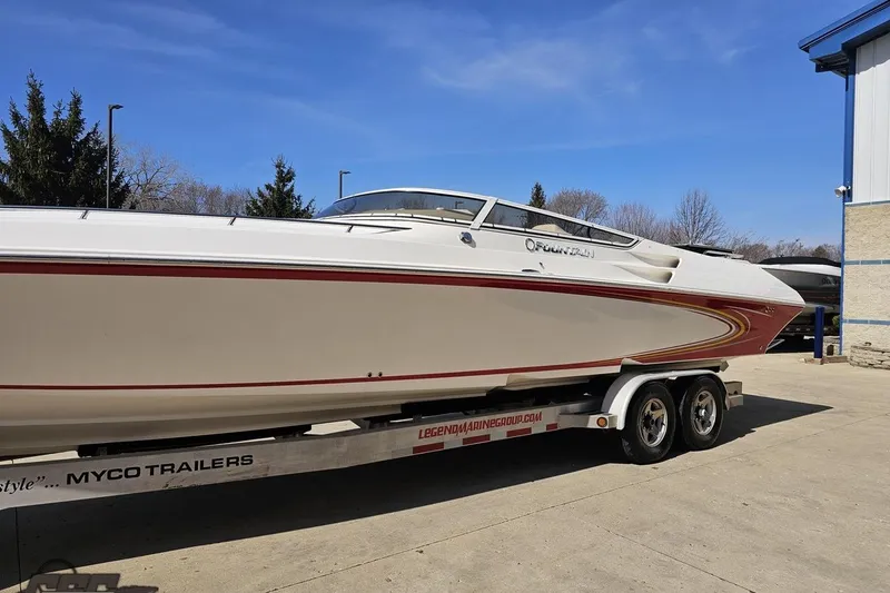 Slide: The Image of 2007 Fountain 35 Lightning speedboat on trailer, white with red accents, parked outdoors. - 19