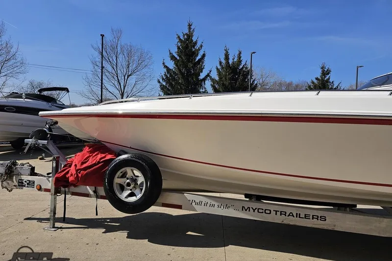 Slide: The Image of 2007 Fountain 35 Lightning boat on Myco trailer, parked outdoors under clear blue sky. - 20